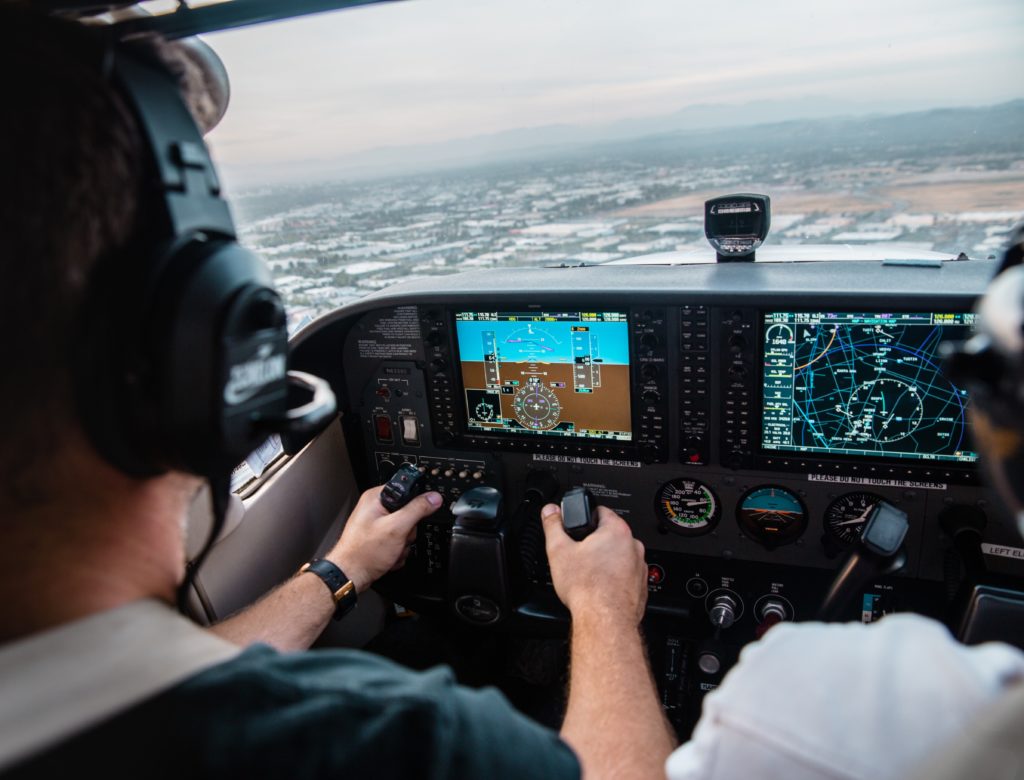 A man sitting in the cockpit of a small airplane